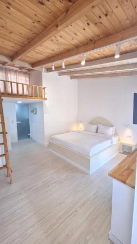 a bedroom with a bed and a wooden ceiling at Tonea's Houses in Himare
