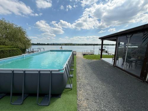a swimming pool with a view of the water at Fishing Trip Divici in Divici
