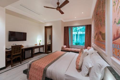 a bedroom with a large bed and a desk at Panna Vilas - A Lake Facing Boutique Hotel in Udaipur