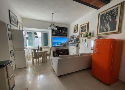 a kitchen and living room with a couch and a refrigerator at Amiata Escape in Arcidosso