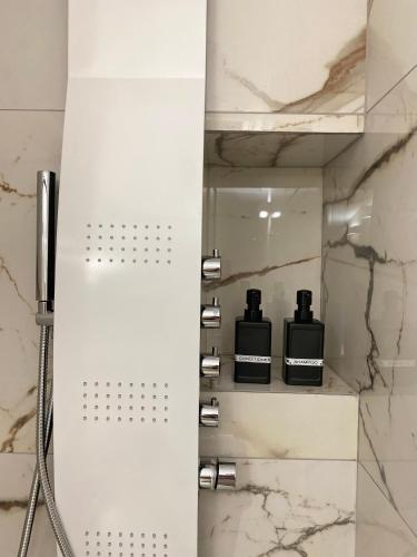 a bathroom with a shower with two shampoo bottles at Casa Moniga 2-Residenze Lizzeri in Moniga