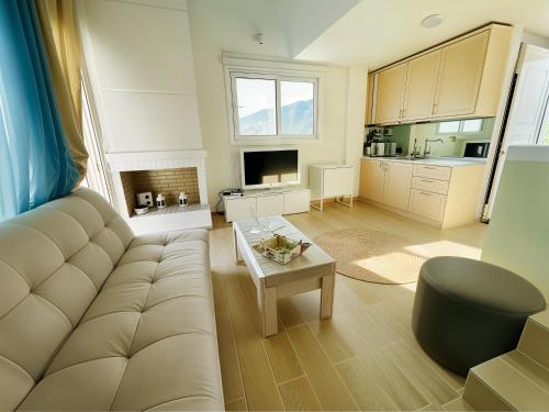 a living room with a couch and a table at Syllas Grand Resort - Executive View Villa 1 in Edipsos