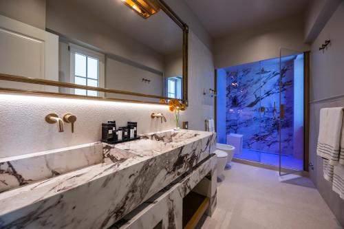 a bathroom with two sinks and a large mirror at HT6 Maison in Rome