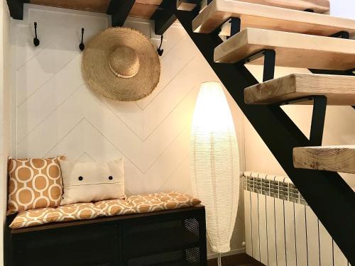 a room with a bench with a hat on the wall at Casa del concejo segovia in Segovia