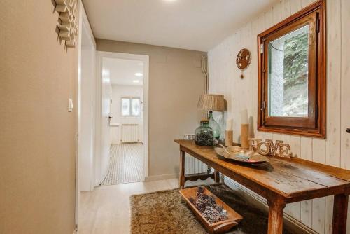 a room with a table and a window and a hallway at CASA FIR by Cardi Suites in Formigal
