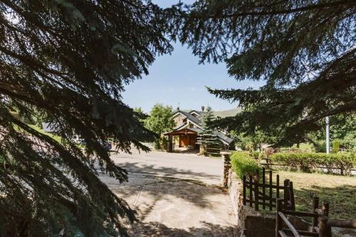 a view of the house from the trees at CASA FIR by Cardi Suites in Formigal