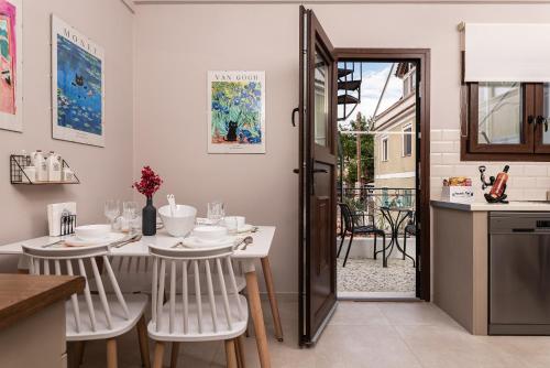 a kitchen and dining room with a table and chairs at Aegealis Stay in Samos