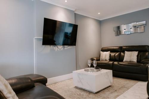 a living room with a couch and a table at Badger Lane - 3 Bedroom House, parking and garden! in Thornaby on Tees