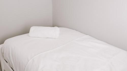 a white bed with a white pillow on top of it at Badger Lane - 3 Bedroom House, parking and garden! in Thornaby on Tees