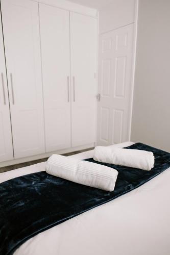 a room with two towels on a black blanket at Badger Lane - 3 Bedroom House, parking and garden! in Thornaby on Tees