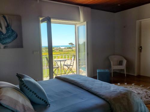 a bedroom with a bed and a view of a patio at Casamilia Suite Parentale in Esposende