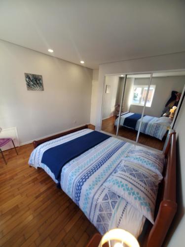 a bedroom with a large bed and a mirror at Casamilia Suite Parentale in Esposende