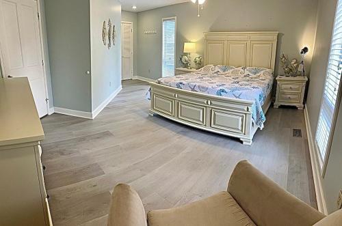 a bedroom with a bed and a couch at Beach Bum Paradise Edisto Beach with Pool in Edisto Island
