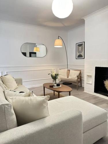 a living room with a couch and a fireplace at Modern Apartment Near Newport City Centre! in Newport