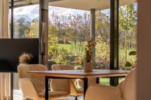 a dining room with a table and chairs and a large window at Boutique Hotel AMARIL in Castelbello-ciardes