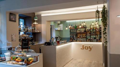 a shop with a joy sign in front of a bar at LHE Iside in Bagno di Romagna