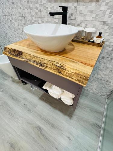 a bathroom with a bowl sink on a wooden counter at Bella Casa Bed and Breakfast in Ponta Delgada