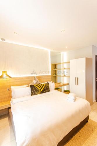 a bedroom with a large white bed in a room at Accra Luxury Apartments @ The Signature in Accra