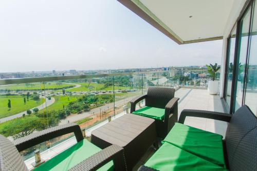 a balcony with tables and chairs and a view of a street at Accra Luxury Apartments @ The Signature in Accra
