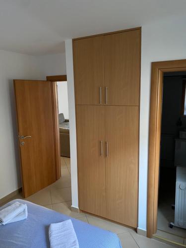 a bedroom with a bed and wooden cabinets at 3bdr apartment in Kotor in Donji Stoliv
