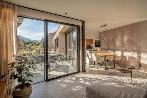 a kitchen and living room with a sliding glass door at Boutique Hotel AMARIL in Castelbello-ciardes