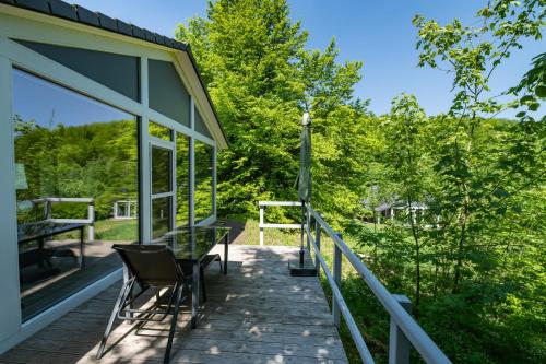 a deck with chairs and a table on a house at 4 Personen mit Sauna F2H6 in Ruhla