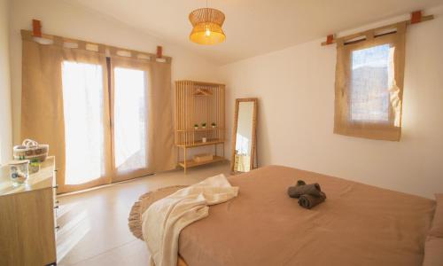 a bedroom with a bed with a teddy bear on it at Rena & Agua Apartments in Siniscola