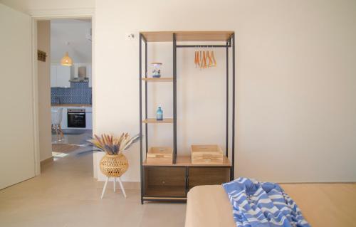 a living room with a bookcase in a room at Rena & Agua Apartments in Siniscola
