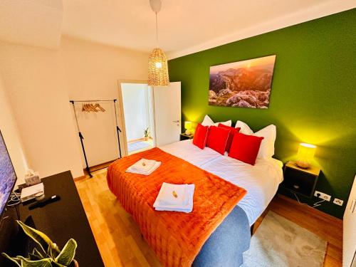 a bedroom with a large bed with red pillows at Joes cozy Apartment in Payerbach
