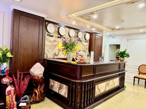 a lobby with a counter with clocks on the wall at Bảo Anh Hotel in Hanoi