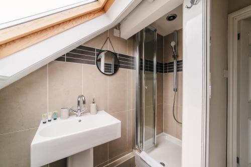 a bathroom with a sink and a shower at Stylish & Well Equipped Modern Home HS2, NEC, Heartlands in Birmingham