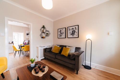 a living room with a couch and a table at Stylish & Well Equipped Modern Home HS2, NEC, Heartlands in Birmingham