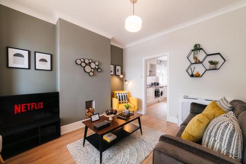a living room with a couch and a table at Stylish & Well Equipped Modern Home HS2, NEC, Heartlands in Birmingham