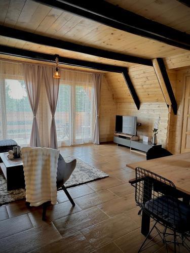 a large living room with a couch and a table at Planinska Brvnara Zlatni Bor in Nedići