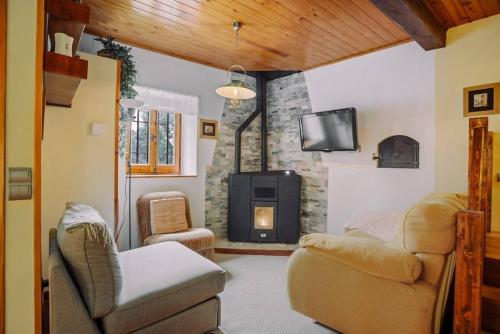 a living room with a couch and a fireplace at Casa Rural Arix by Cardi Suites in Sallent de Gállego