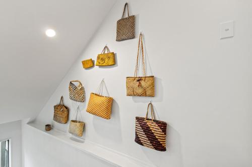 a group of purses hanging on a wall at Harakeke Whāre - Christchurch Holiday Homes in Christchurch