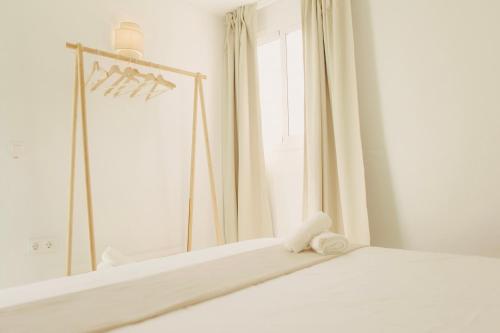 a bedroom with a bed and a mirror at GAIA Beach House - Exclusive Stay & Free Parking in Conil de la Frontera