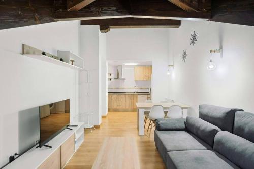 a living room with a couch and a table at LINA by Cardi Suites in Escarrilla