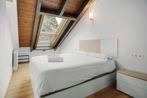 a bedroom with a large bed and a window at LINA by Cardi Suites in Escarrilla