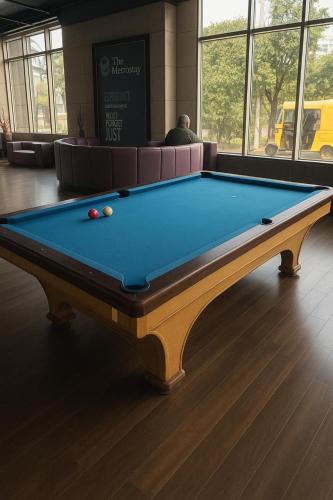 a pool table with two balls on top of it at The Metrostay Opposite New Delhi Railway Station, Above Metro, 20 Mins From IGI Airport in New Delhi