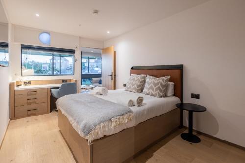 a bedroom with a large bed and a desk at The SPACE To Stay, St Andrews in St. Andrews