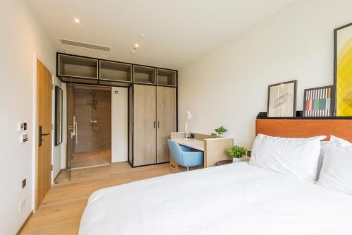 a bedroom with a white bed and a desk at The SPACE To Stay, St Andrews in St. Andrews