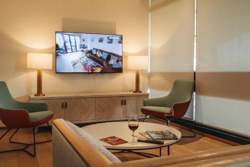 a living room with a table and two chairs and a tv at The SPACE To Stay, St Andrews in St. Andrews
