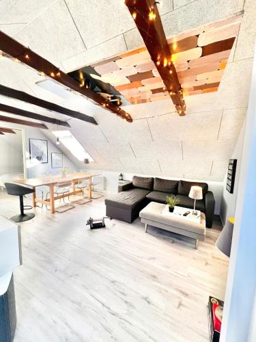 a living room with a couch and a table at Dalgade loft and living in Vejle