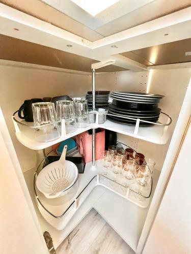 an open refrigerator with plates and dishes in it at Dalgade loft and living in Vejle