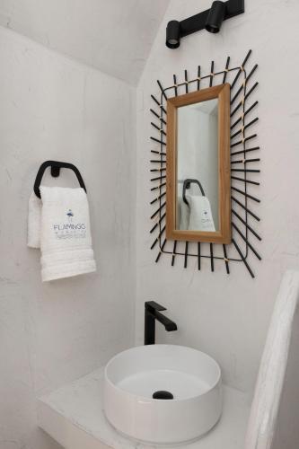 a bathroom with a white sink and a mirror at Flamingo Living Halkidiki - The Villas in Áyios Mámas
