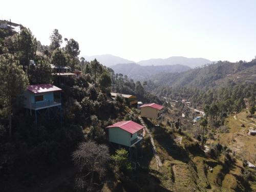 a group of houses on the side of a hill at Shaantvan Homestay-Near Bhalughar Waterfall-Mukteshwar in Mukteswar