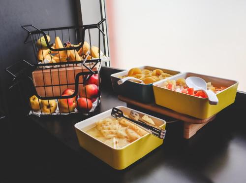 a table with three trays of food on it at ibis Bucharest Politehnica in Bucharest