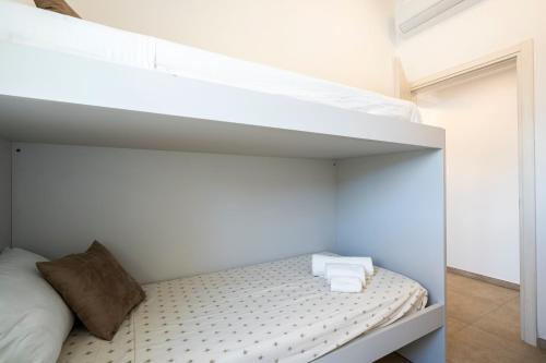a bedroom with a bunk bed with white walls at Appartamento Luxury vista mare in Lido di Camaiore