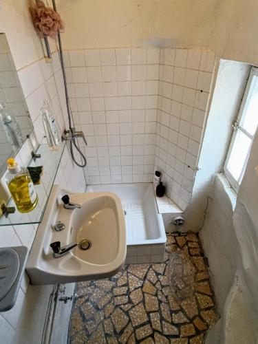 une salle de bain avec un lavabo et une baignoire dans l'établissement Séjour dans la cité fortifiée, à Colmars